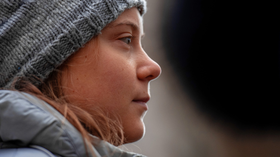 Profile view of activist Greta Thunberg, looking contemplative
