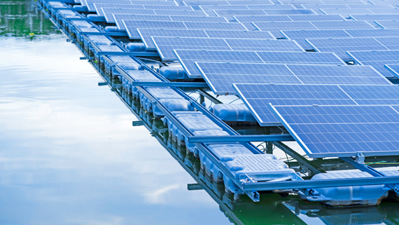 Large expanses of solar panels floating on a reservoir