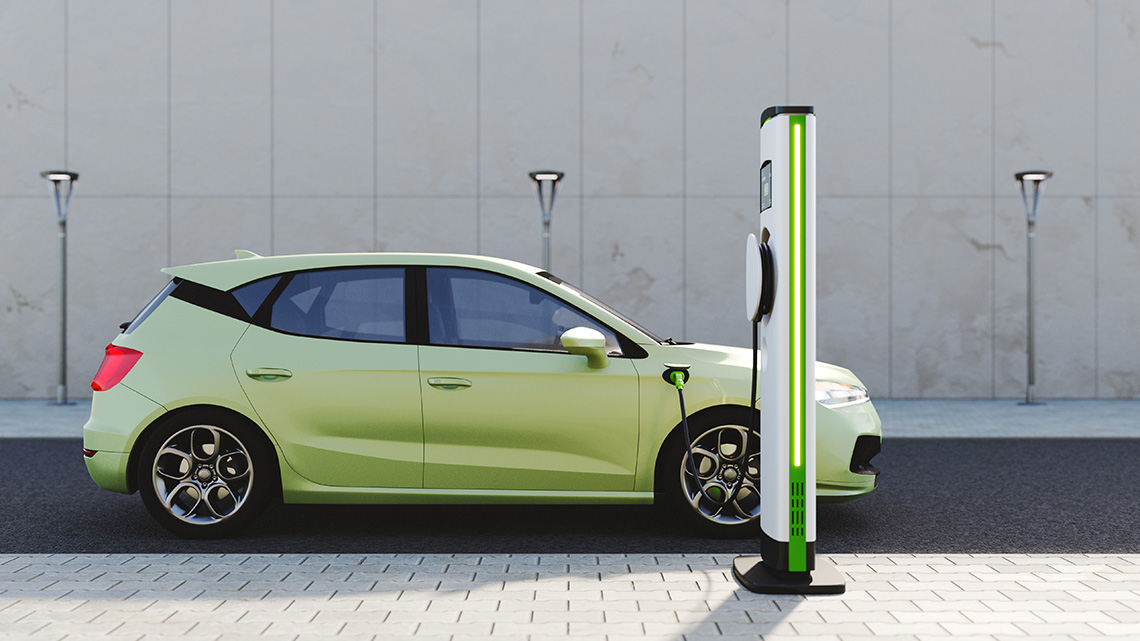 An electric car parked and plugged in at a charging station.
