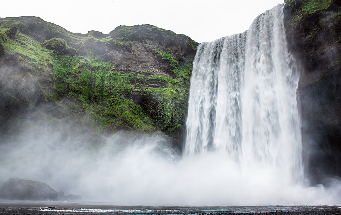 A waterfall with water at the bottom.