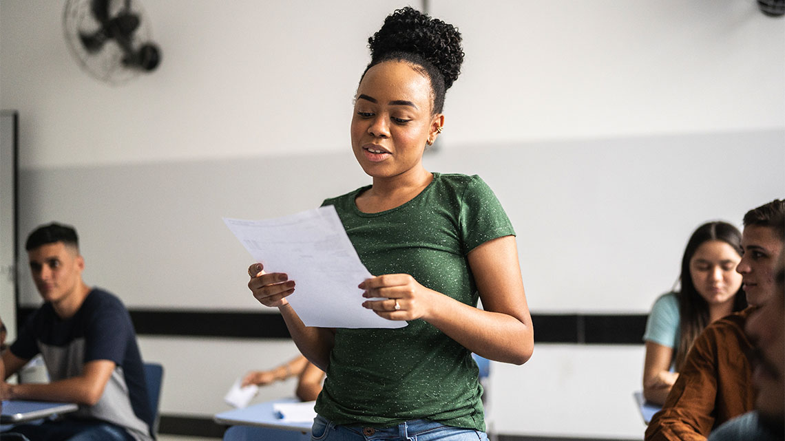 A student presenting work in a classroom.
