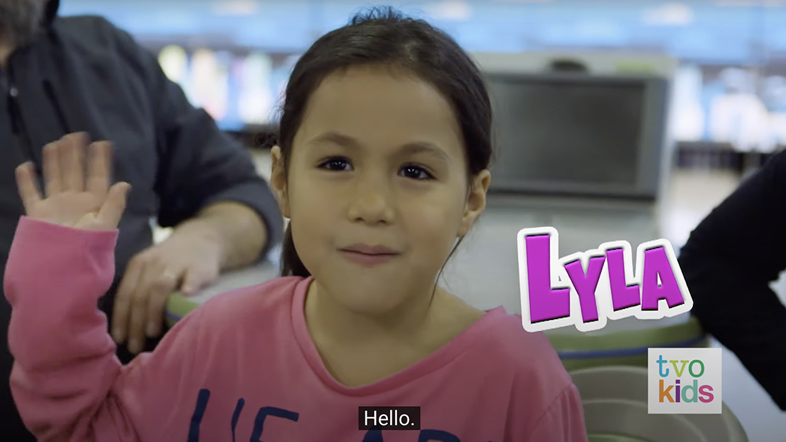 Simon's sister Lyla says hello and waves her hand several times.