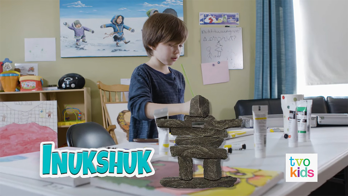 Simon is painting. There is an inukshuk symbol next to the word inukshuk at the bottom of the image.