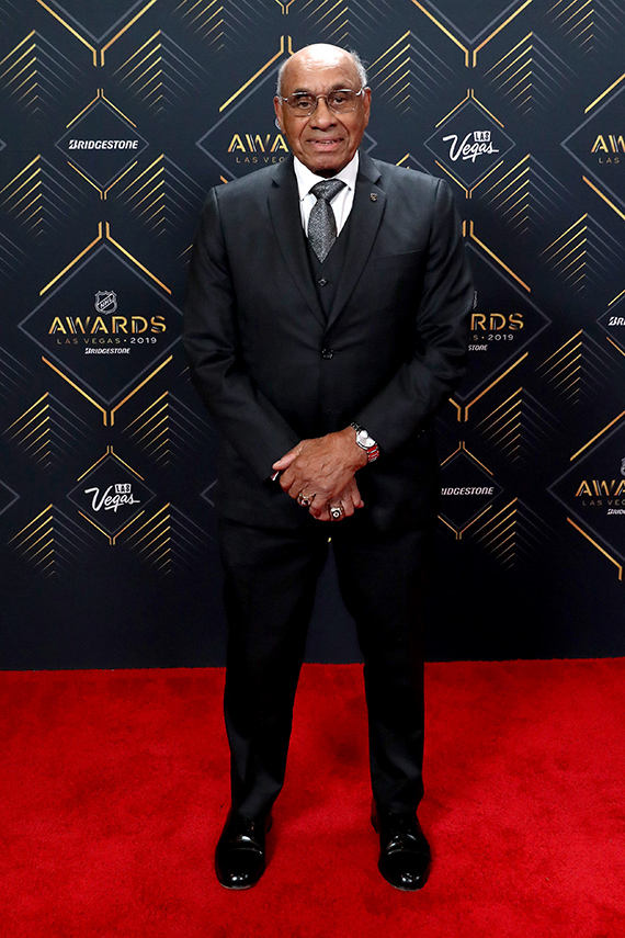 A photograph of hockey player Willie O’Ree at an awards ceremony.