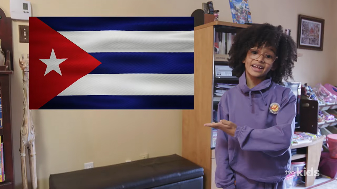 Valexia is introducing themselves, next to a Cuban flag.