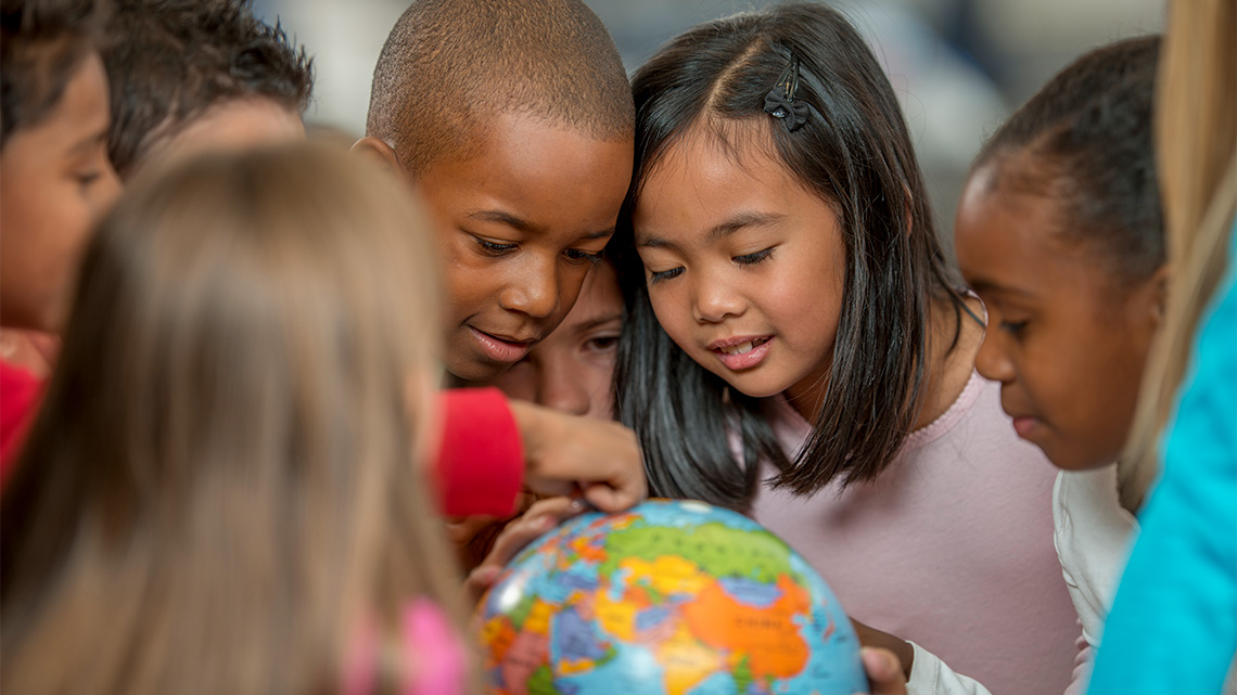 Students around a globe.