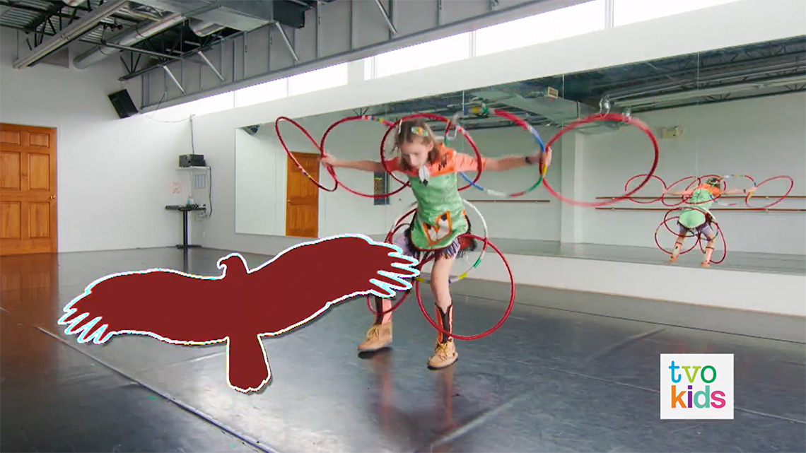 Emily shows how hoops on her arms, back, and legs can help her make a eagle shape.