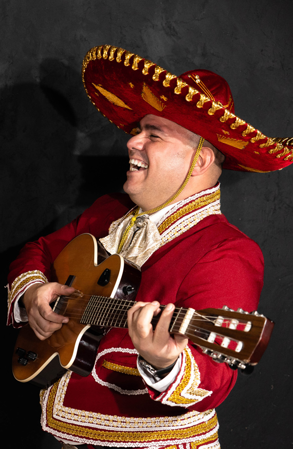 A Mariachi musician playing a vihuela.