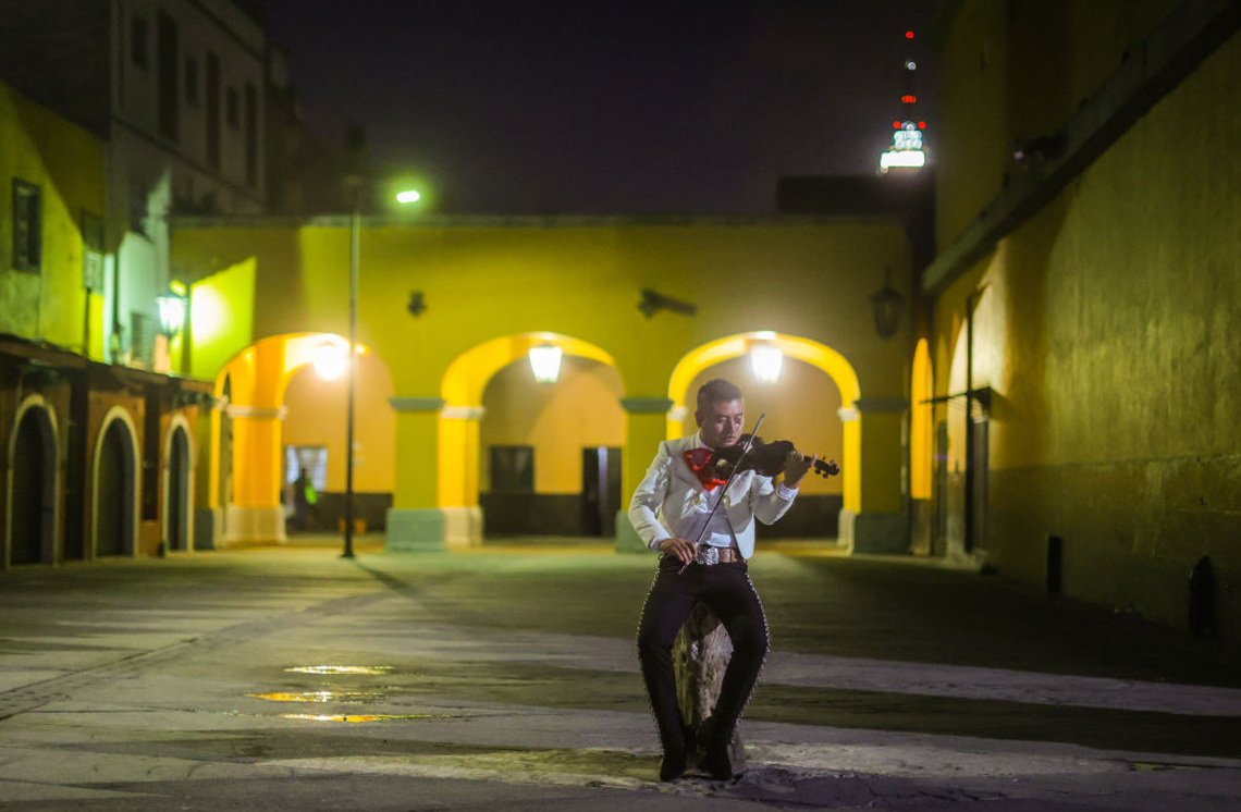A Mariachi musician playing a violin.