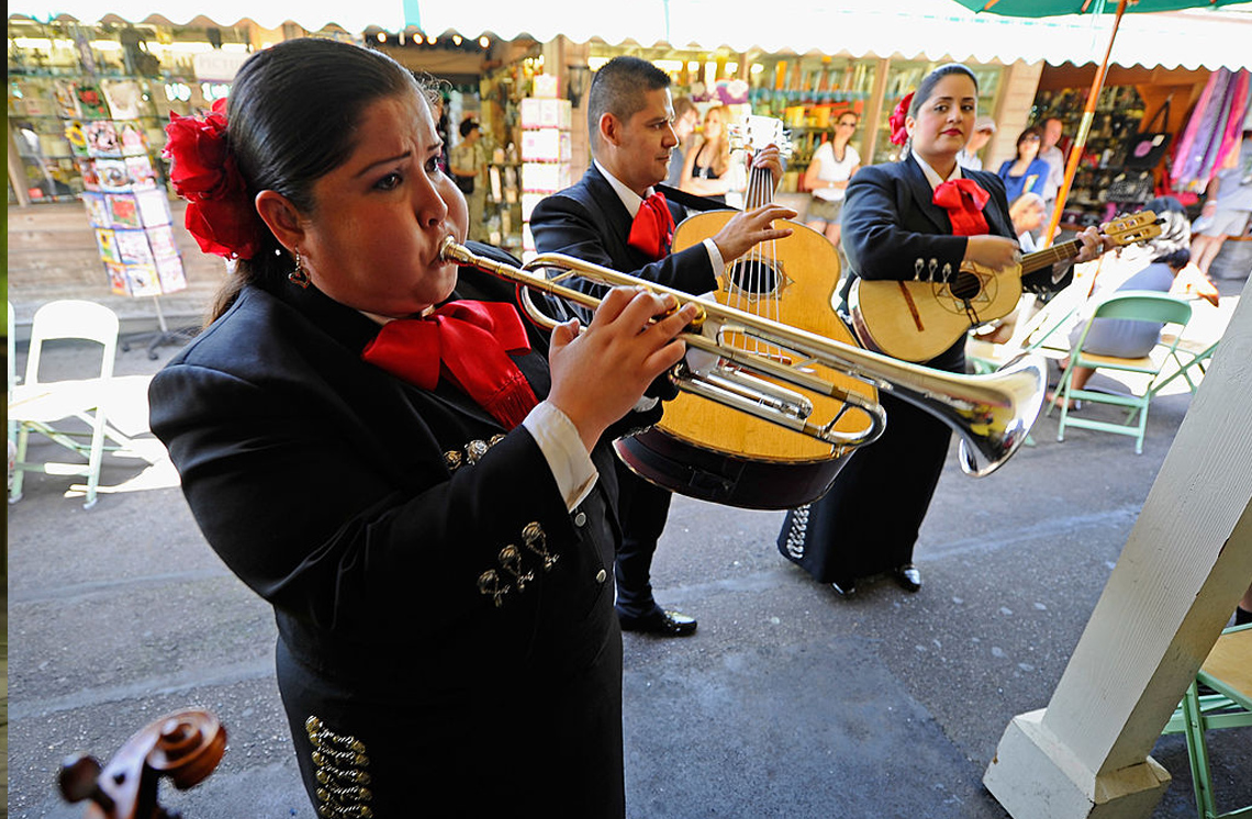 A Mariachi musician playing a trumpet.