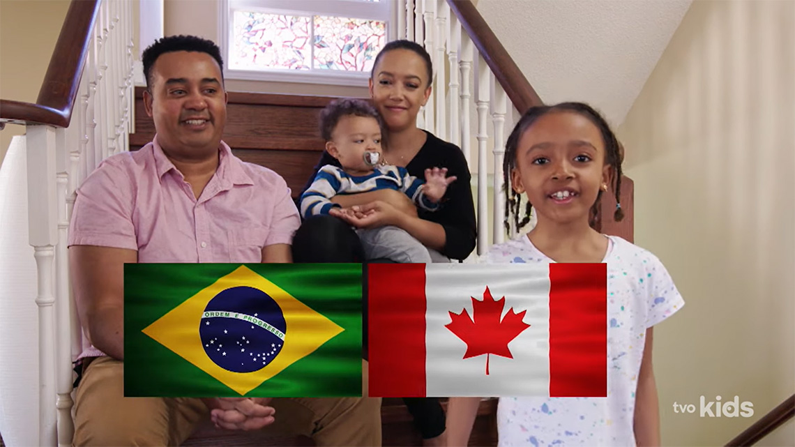 Lulu and her family along with the flag of Brazil and the flag of Canada.