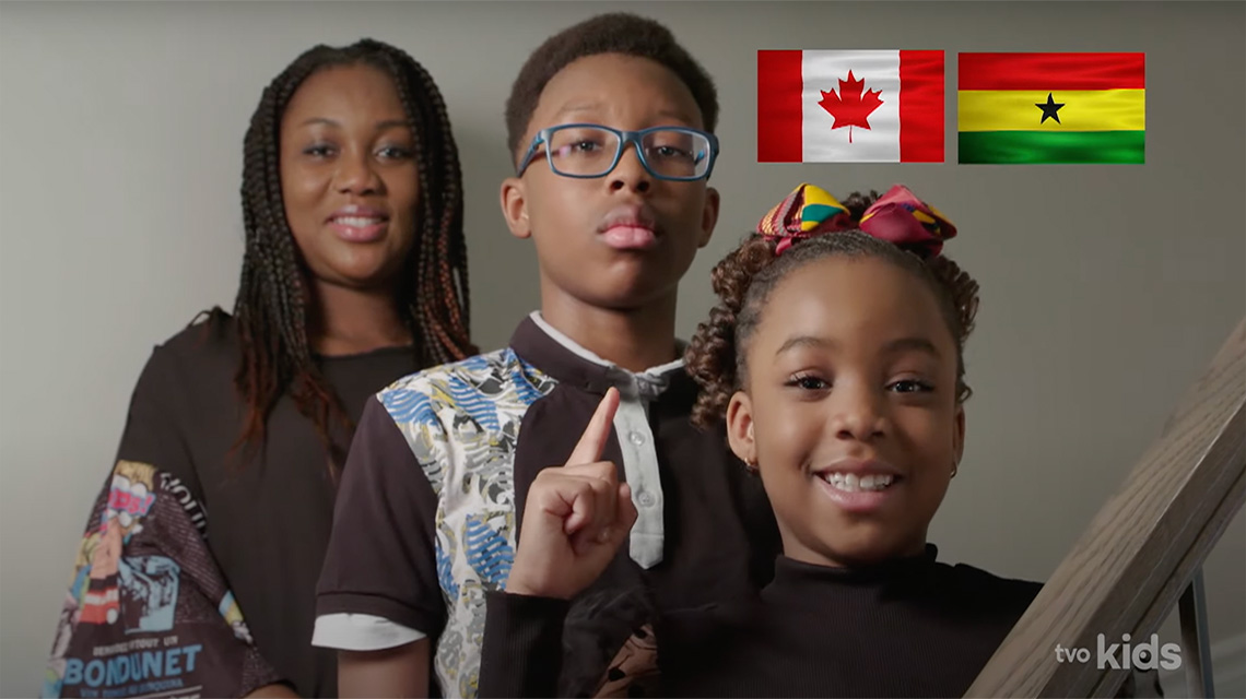 Emily and her family along with the flag of Canada and the flag of Ghana.