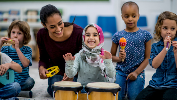 A happy group of diverse students playing instruments.