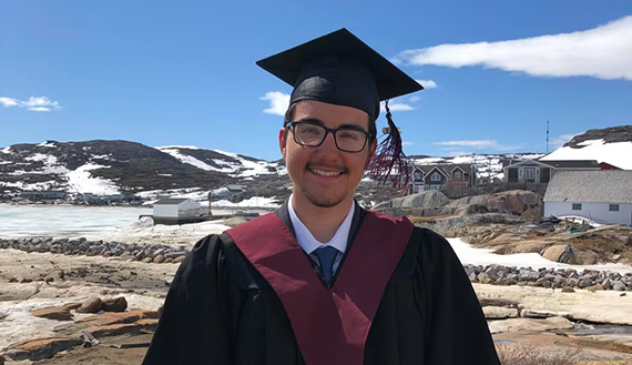 Nicholas Flowers wearing a cap and gown outside in Hopedale, Newfoundland and Labrador