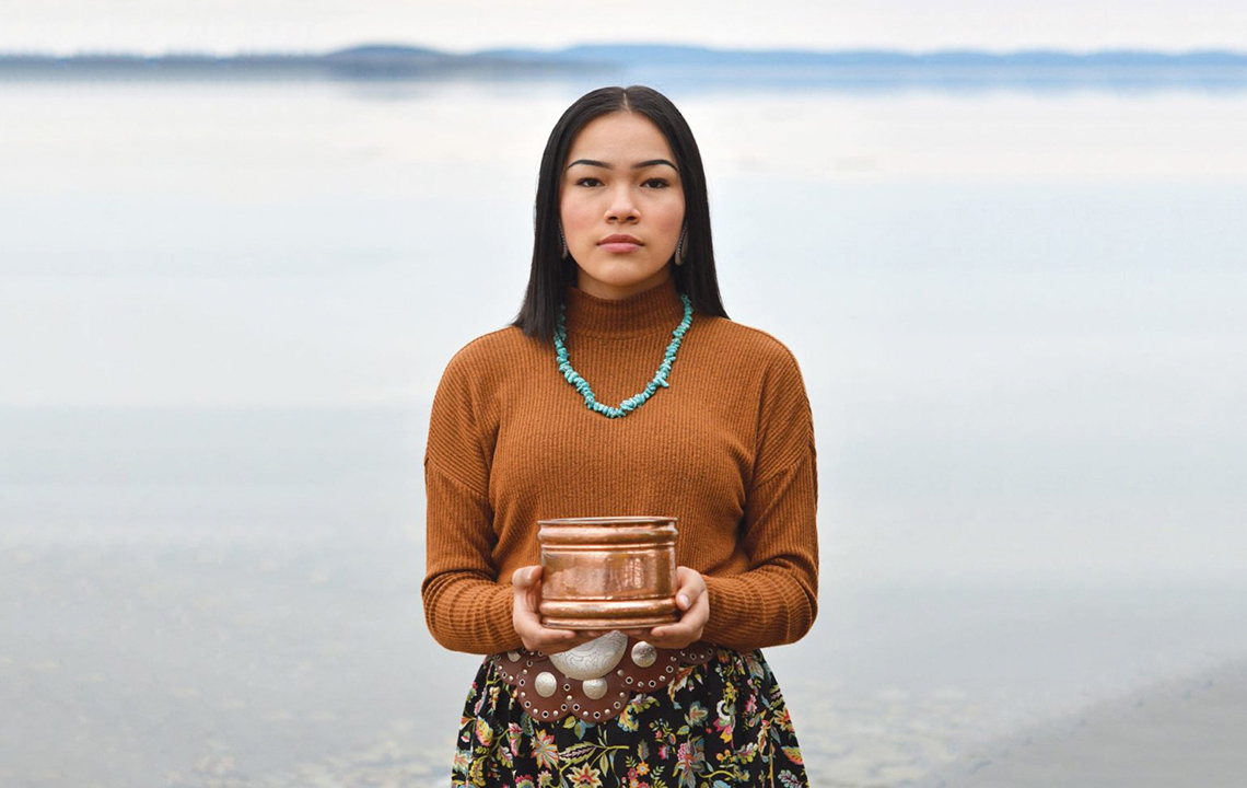 Autumn Peltier standing on a shoreline