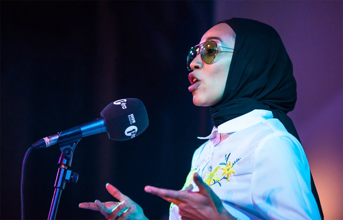 Asma Elbadawi speaking into a microphone