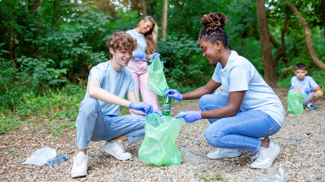 A group of youth cleaning up litter in a park