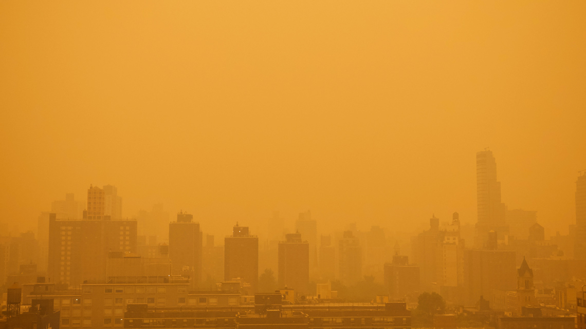 A city skyline covered in smoke from wildfires