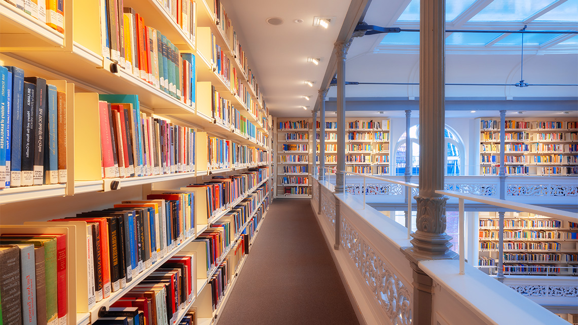 Library interior with bookshelves filled with books.