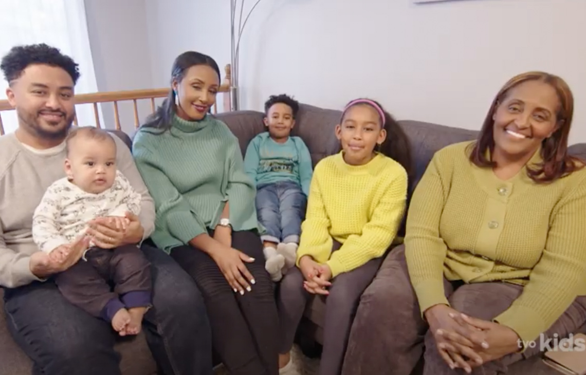 Leah’s father, mother, brothers, and grandmother sitting together on a couch.
