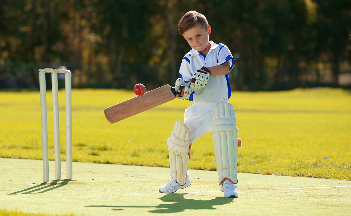 Child playing cricket.