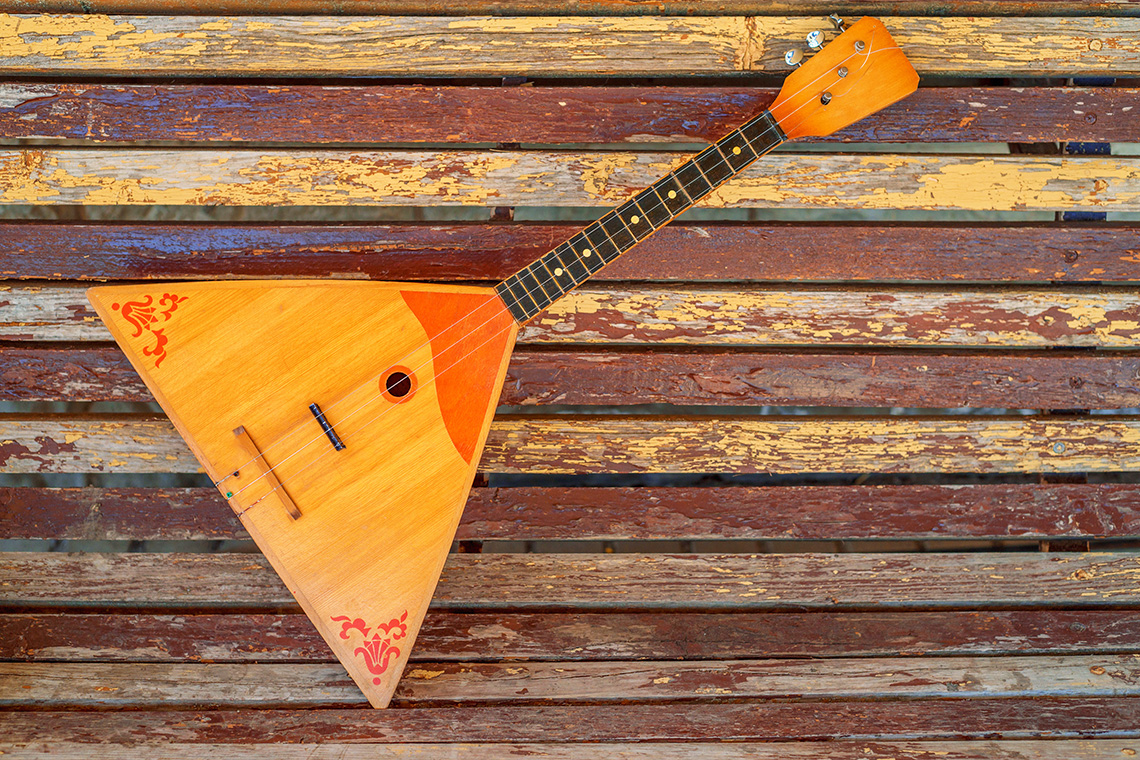 A balalaika, an instrument that looks like a guitar with a triangular body.