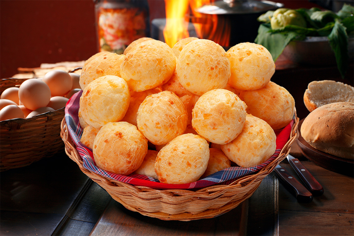 A basket full of puffy cheese buns.