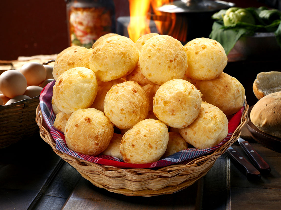 A basket full of puffy cheese buns.
