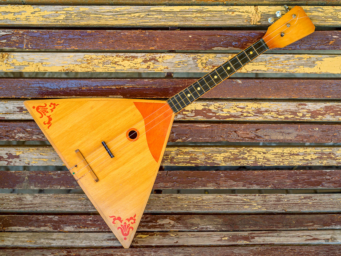 A balalaika, an instrument that looks like a guitar with a triangular body.