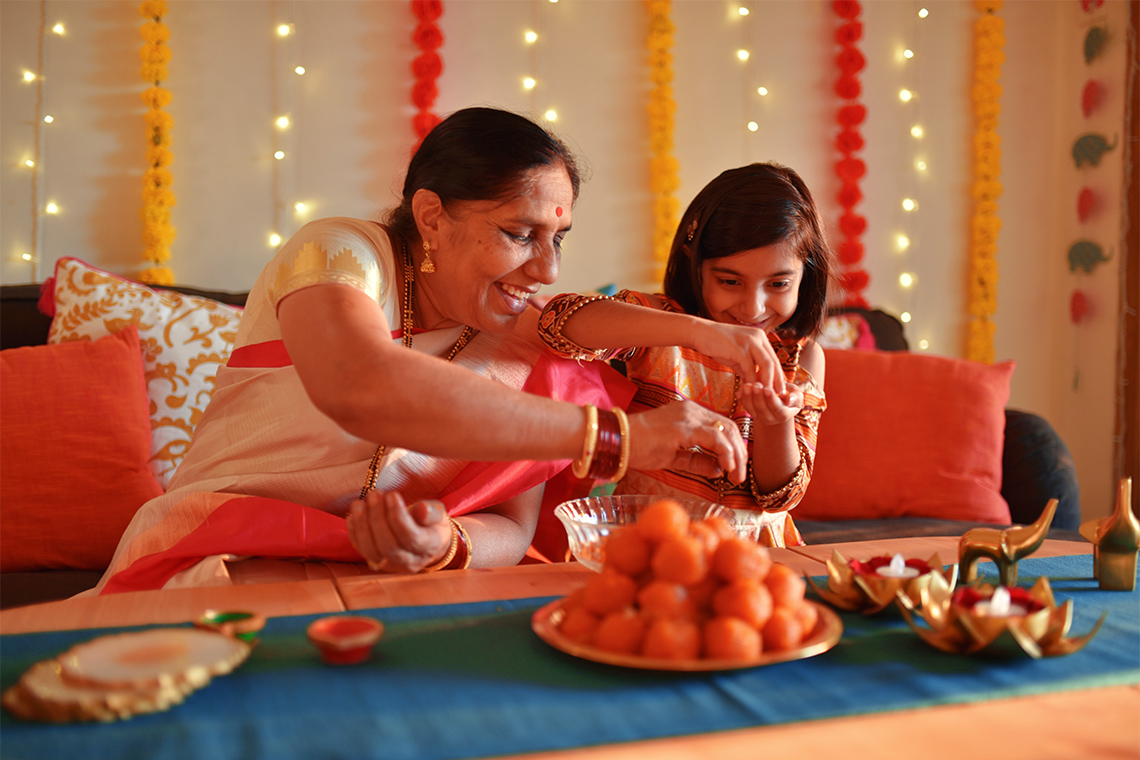 Photo of a girl helping her grandmother cook.