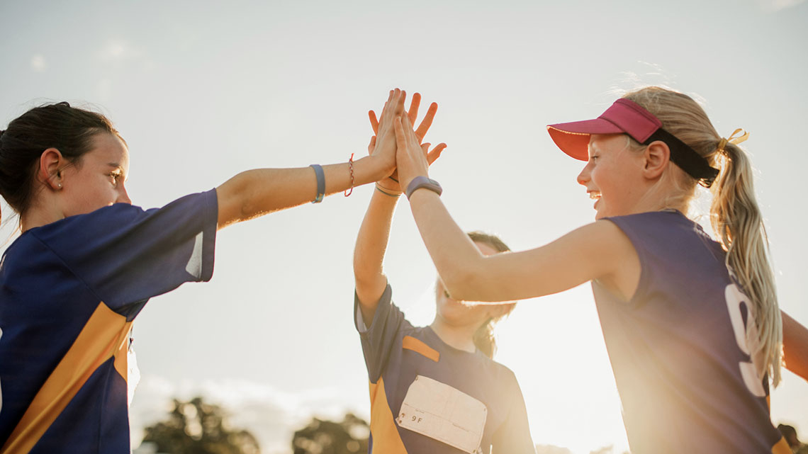 A group of people high fiving each other.