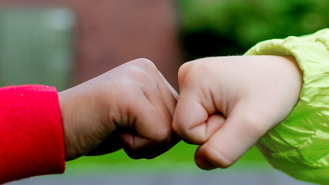Two people fist bumping.