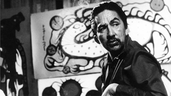 Norval Morrisseau in front of Water Spirit (from the documentary The Paradox of Norval Morrisseau, 1974).