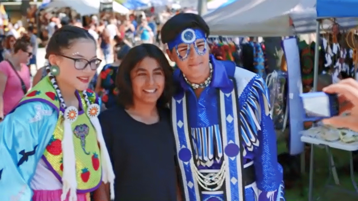 12-year-old Ojibway boy named Joshua with friends at the Lake Curve Powwow.