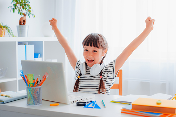 A learner cheering that their desk.