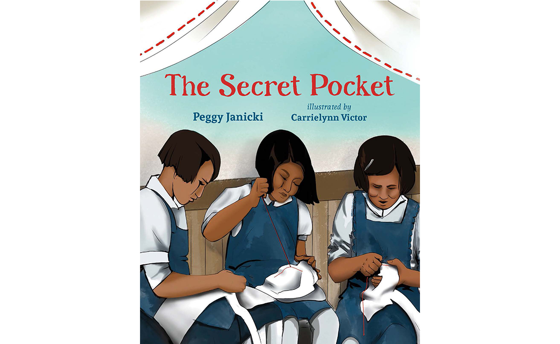 Book Cover of ‘The Secret Pocket,’ Peggy Janicki, illustrated by Carrielynn Victor. 3 girls in uniform are sewing white scraps of cloth.