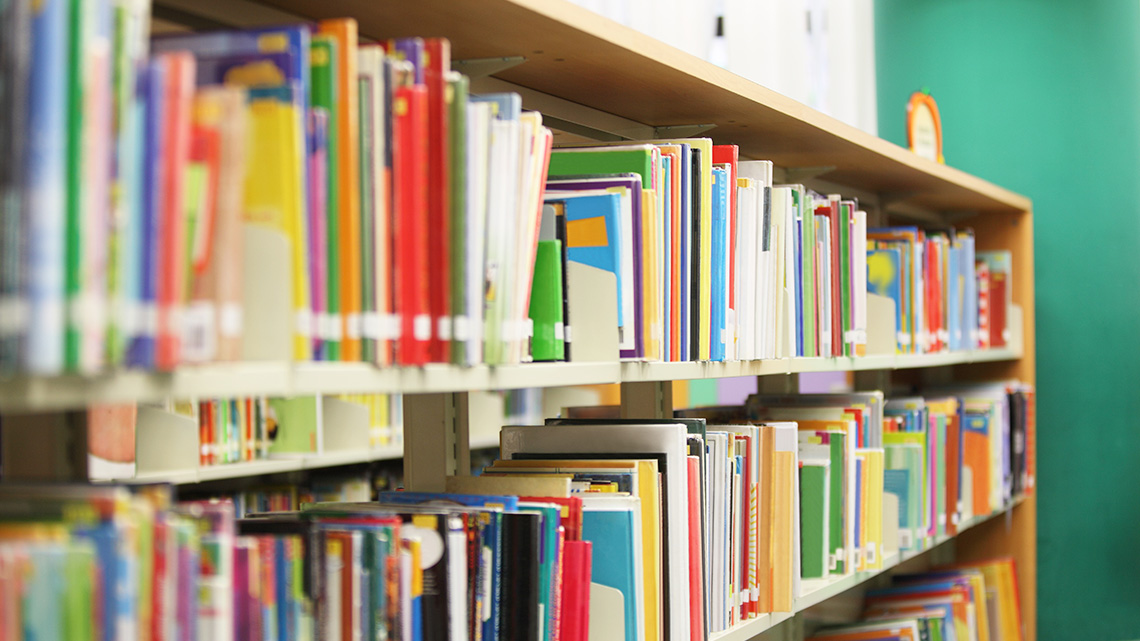 Rows of books on shelves in a library