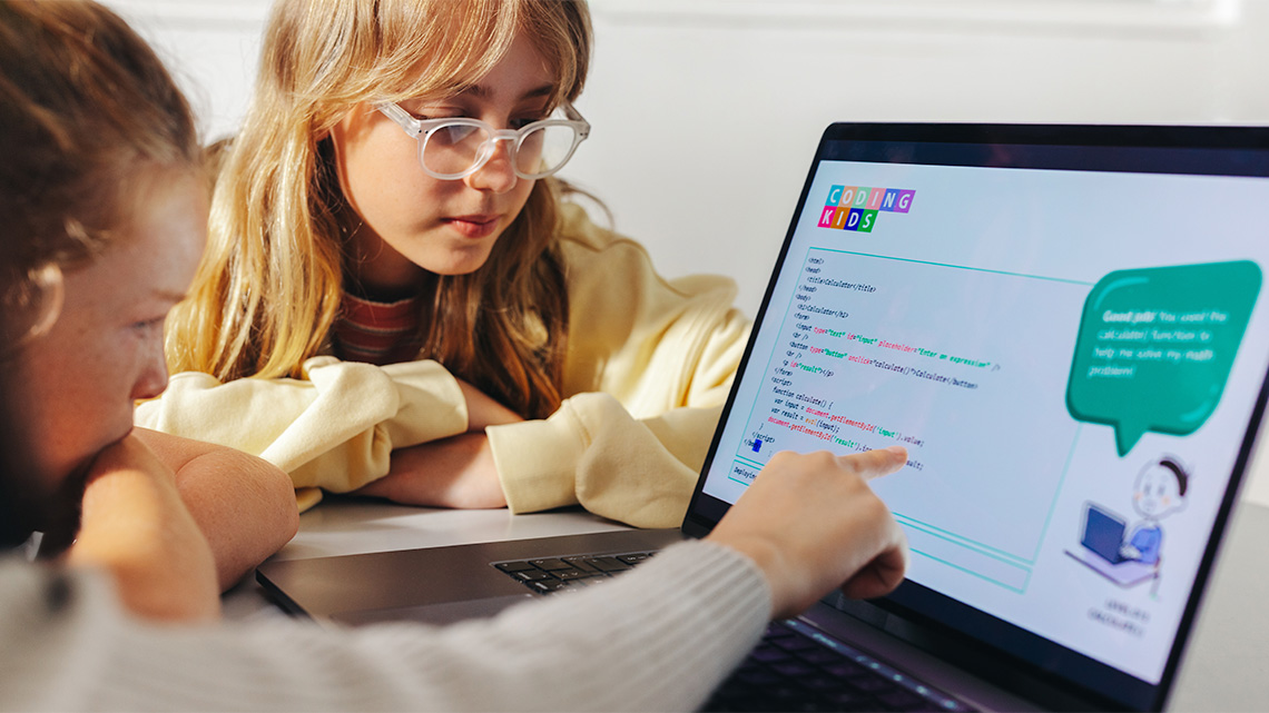 Two elementary school children doing schoolwork on a laptop