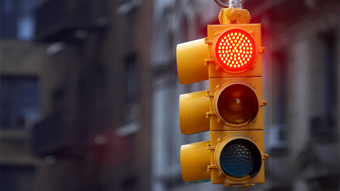 A traffic light with the top, red circle lit up.