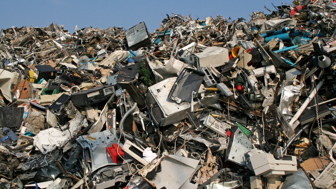 Many broken electronic devices piled up in a landfill