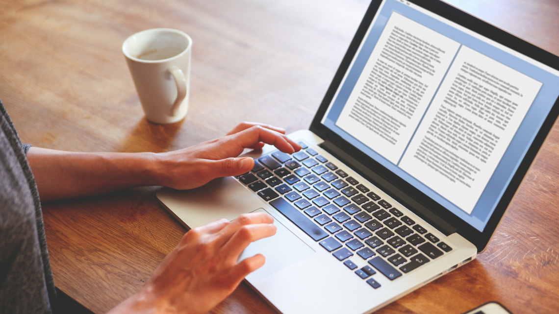 A person reading a document on a computer