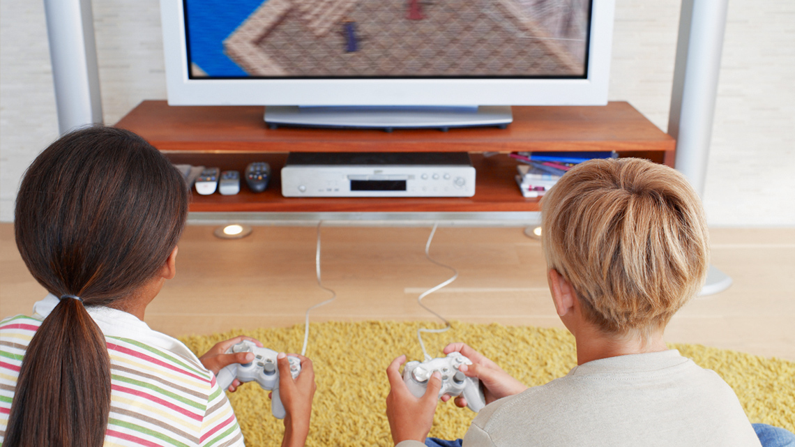 Two kids playing videogames.