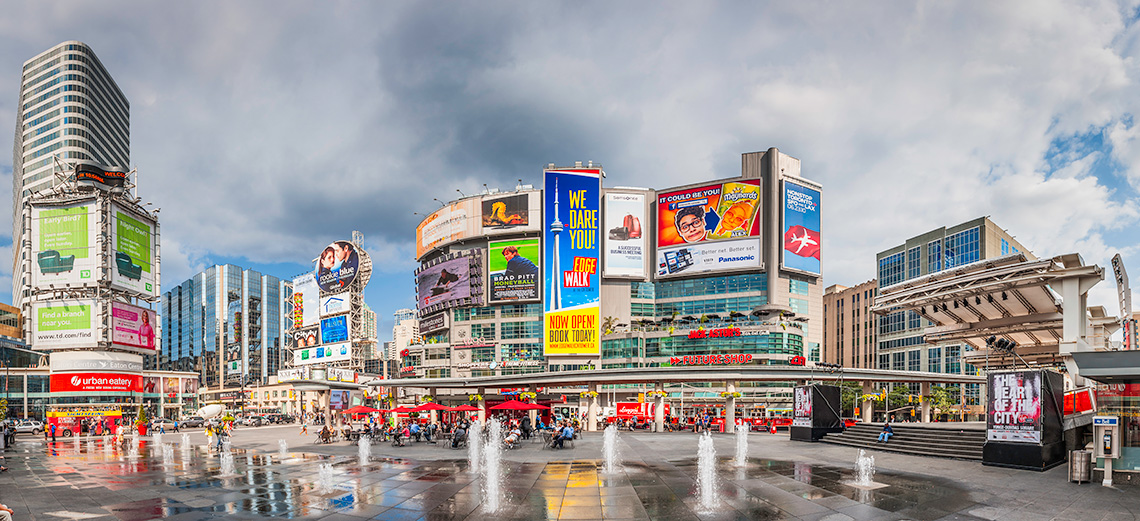 A busy square in downtown Toronto with many advertisements and billboards