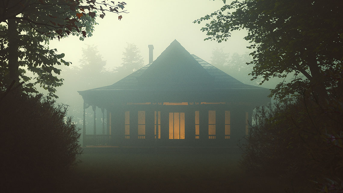 A house in the woods. It is foggy and dark.