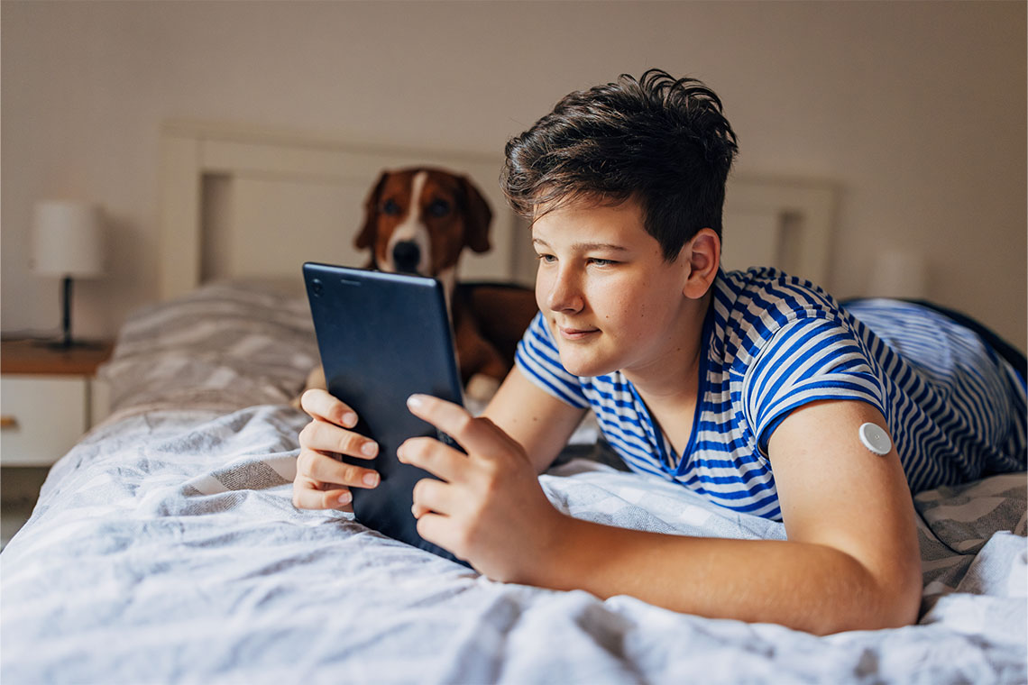 A teen holding a tablet.