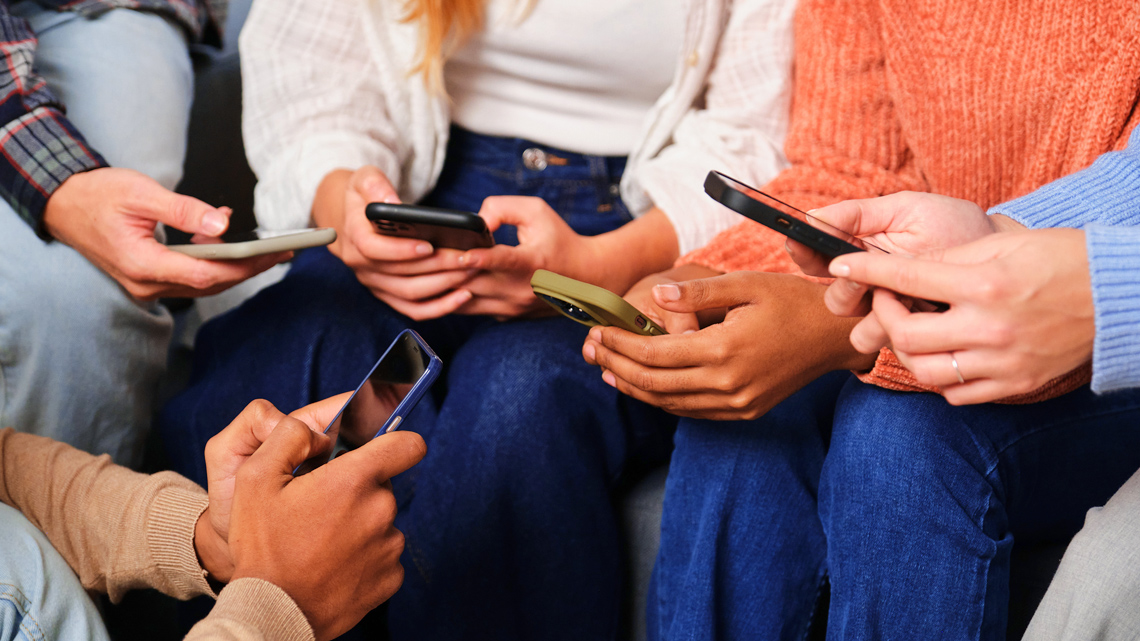 A group of people on their smartphones.