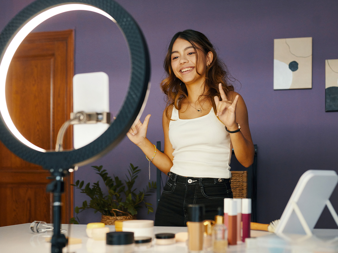 An influencer recording with a ring light.