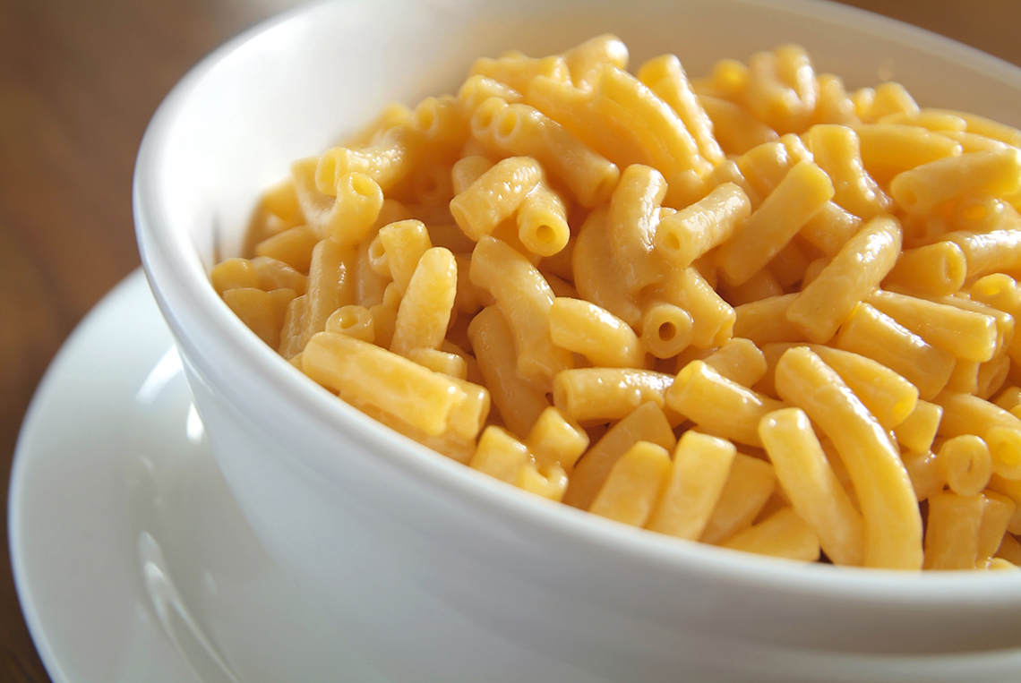 Macaroni covered with cheese sauce.