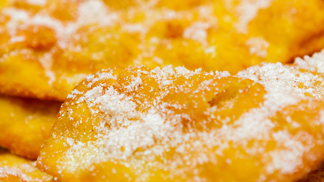 A flat dough pastry covered in cinnamon and sugar.