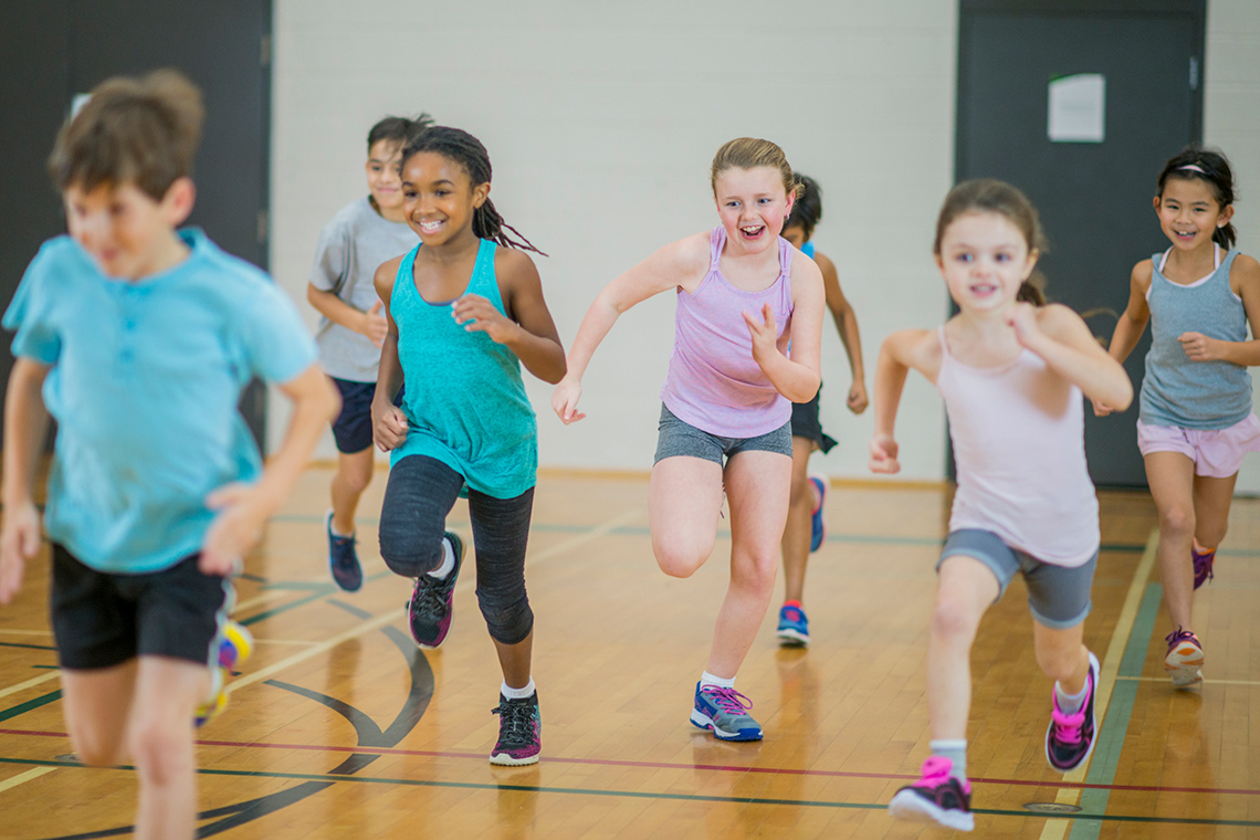 Children running in a gym.